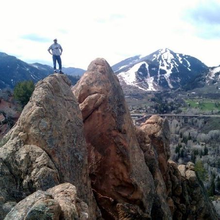 Tory Bjorklund standing on top of a rock outcropping in Colorado, 2009.
