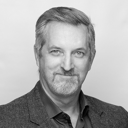 A black and white portrait of Thys Coetzee for his exclusive interview with Victoria Fide on achieving quick ROI, risk management, and more DX insights.